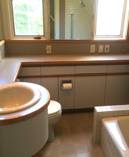 Before: cramped bathroom with too many cabinets